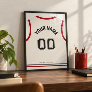 Basketball Jersey Poster in White with Red Sleeves and Black Number, a small A4 framed print leaning on a walnut desk