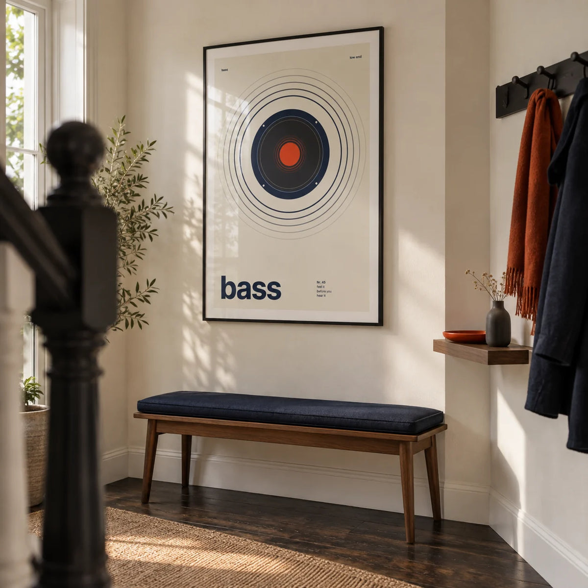 Bass Poster, framed on the wall of a design-led hallway in a UK terraced home with a cream wall and dark timber floor