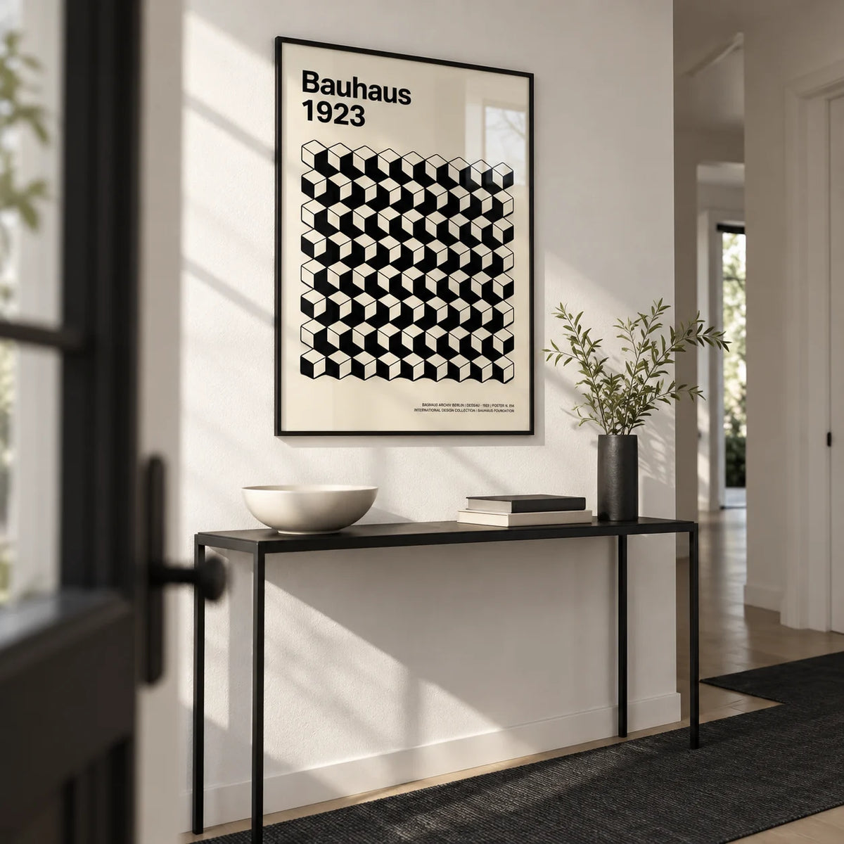 Bauhaus Design, framed on the wall of a crisp monochrome hallway with white walls and a black floor runner