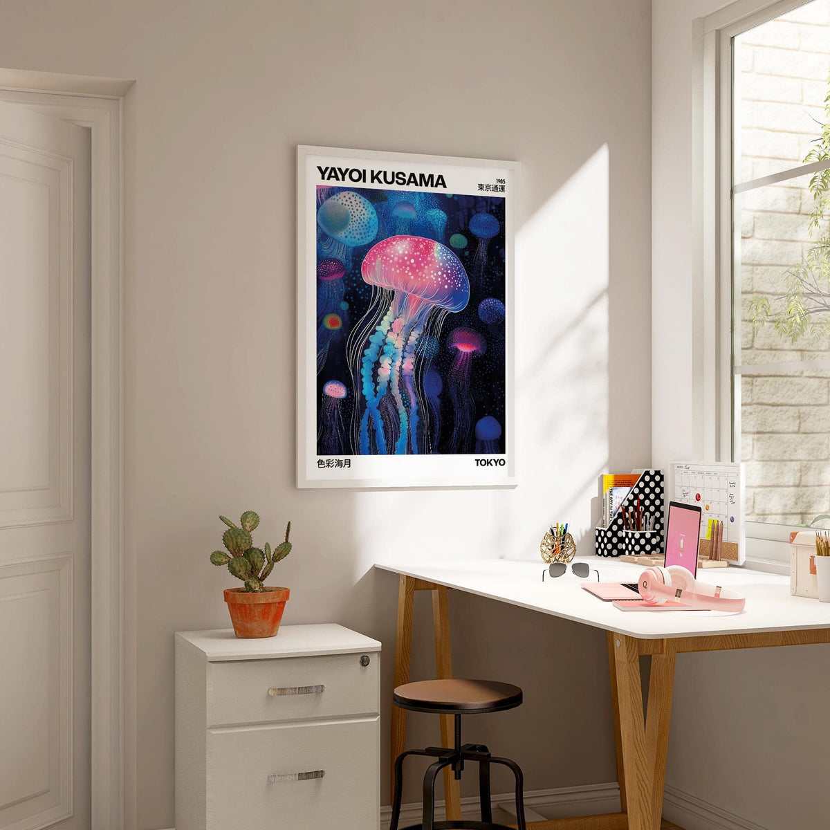 Jelly Fish wall art featuring glowing jellyfish in blue and pink shades above a white desk with a cactus
