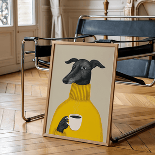 Whimsical Dog Print framed print leaning on a black chair with wooden parquet floor