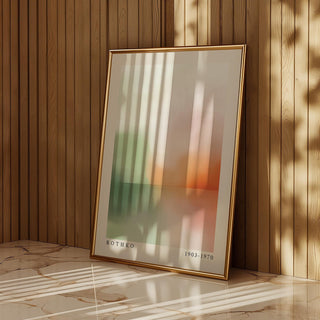 Framed Peaceful wall art print with abstract sunset in soft green and orange leaning against a wooden wall