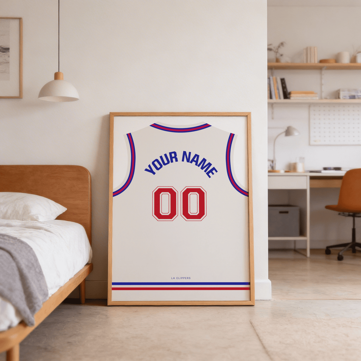 Print leaning on the floor of a bedroom with basketball jersey poster in plain white with red number