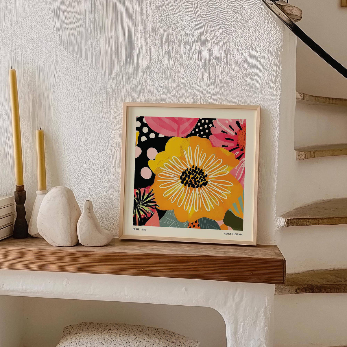Flower Posters print leaning on a wooden shelf with candles and white sculptural objects