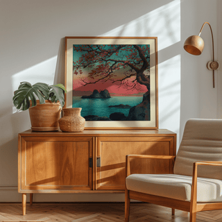 Framed Hasui Kawase Sunset Seascape Print with red maple tree and sea on a wooden sideboard with plants and lamp