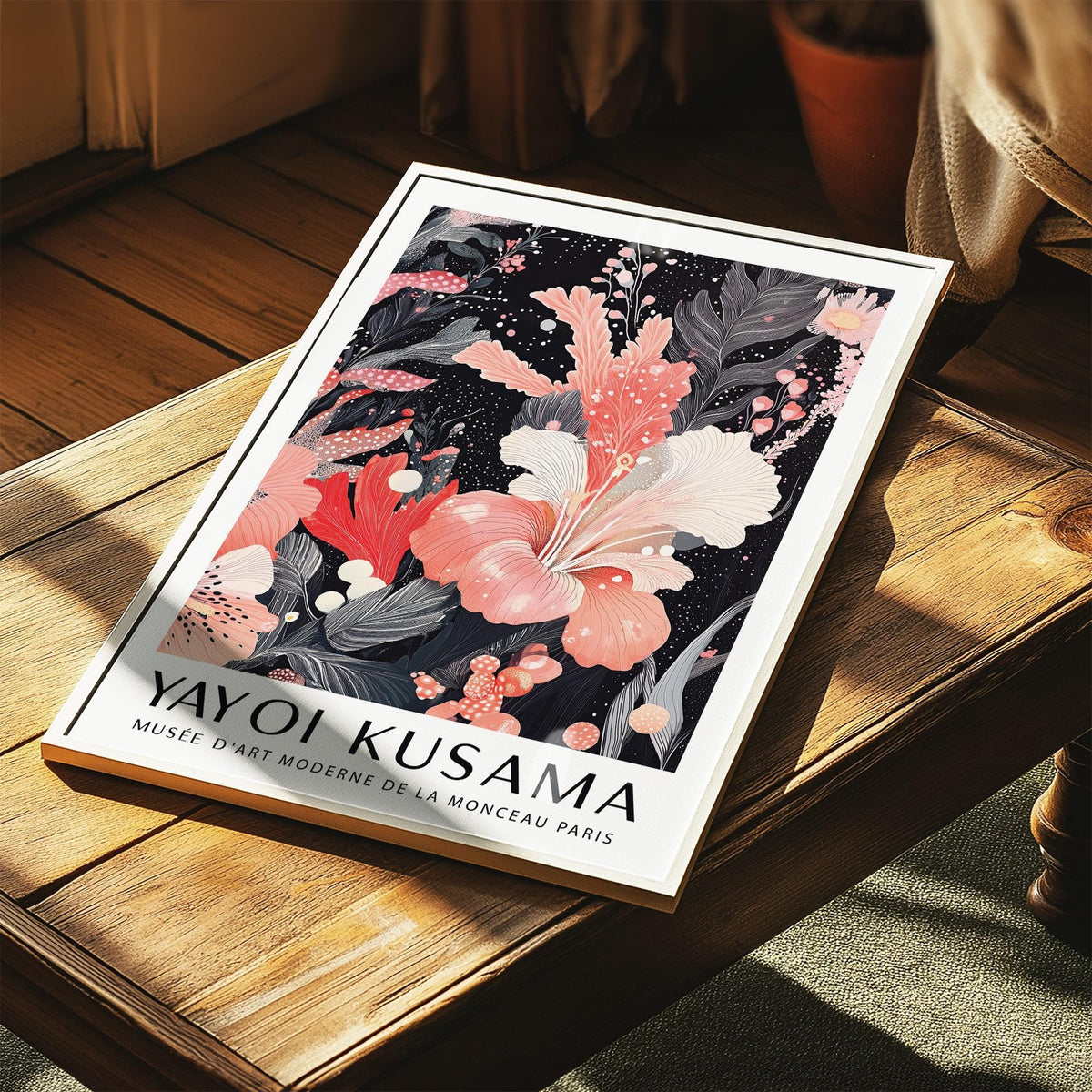 Print featuring black and pink wall art botanical illustration with a pink hibiscus flower lying on a wooden surface
