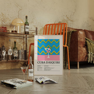 Print leaning on floor of pop-art daiquiri cocktail with blue and yellow zigzags near an orange chair in a living room