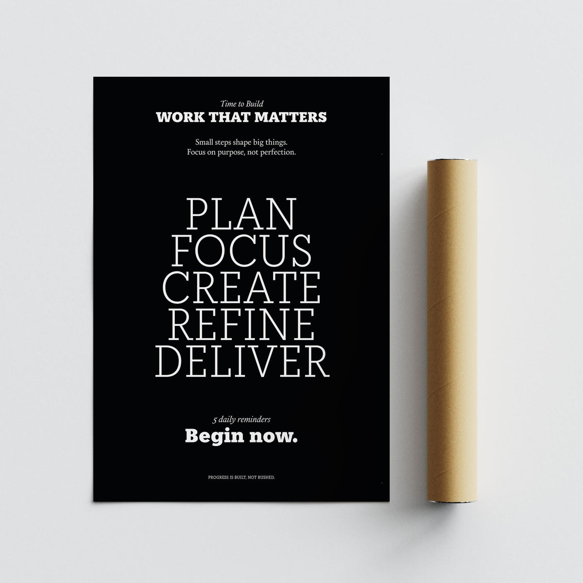 Motivational text art with white text on black beside a rolled packaging tube