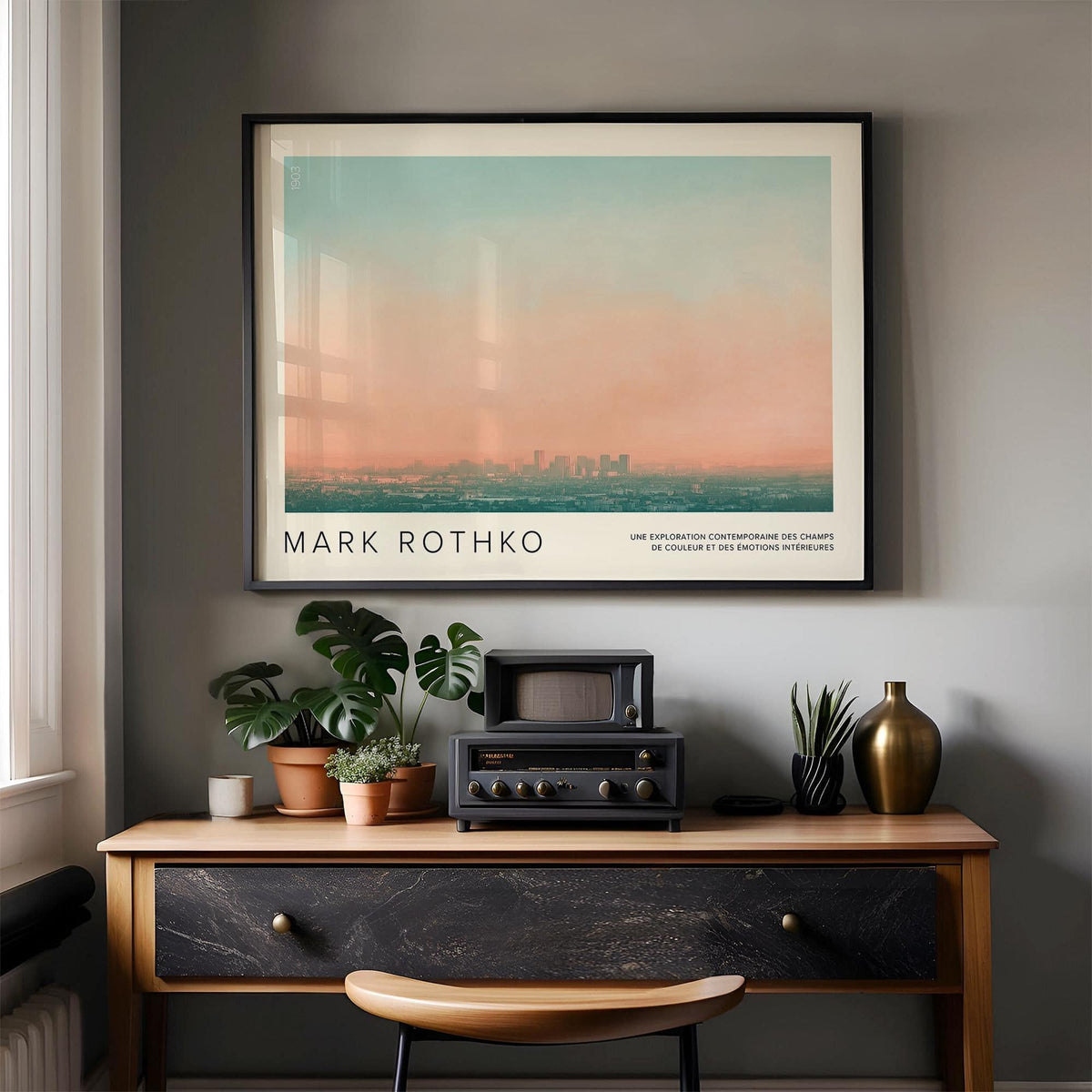 Framed Skyline Wall Pictures photographic city skyline at sunset in soft blue and peach tones above desk with plants and radio