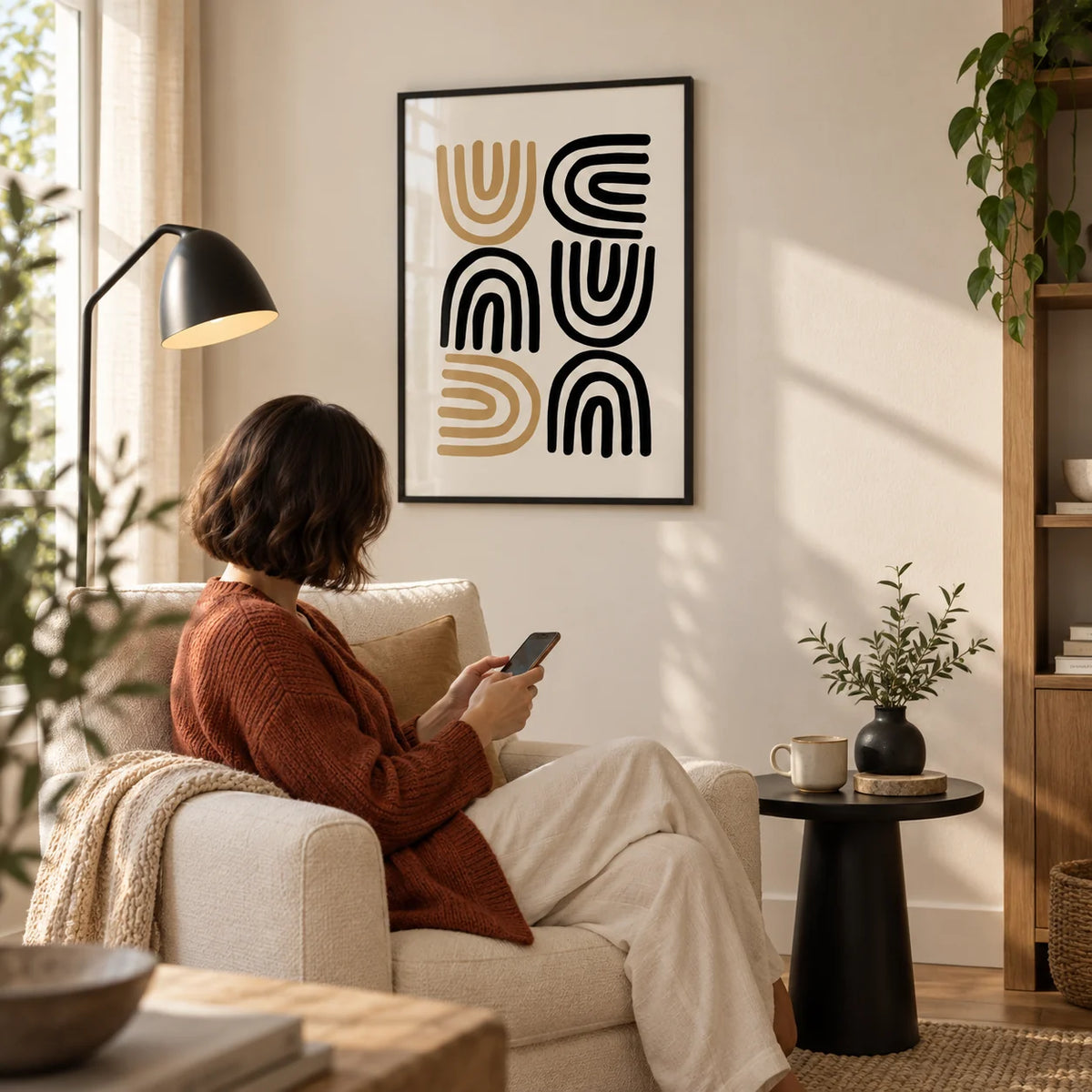 Black and Gold Pictures, framed on the wall of a calm living room corner with a warm white wall