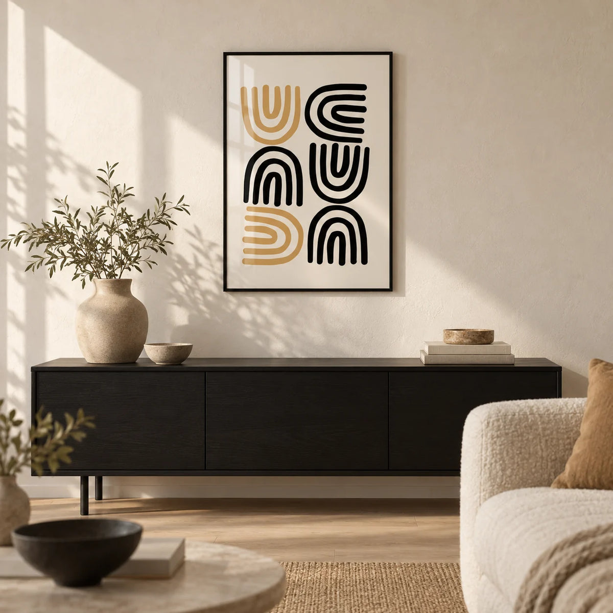Black and Gold Pictures, framed on the wall of a warm minimal living room with an off-white limewashed wall and a pale oak floor