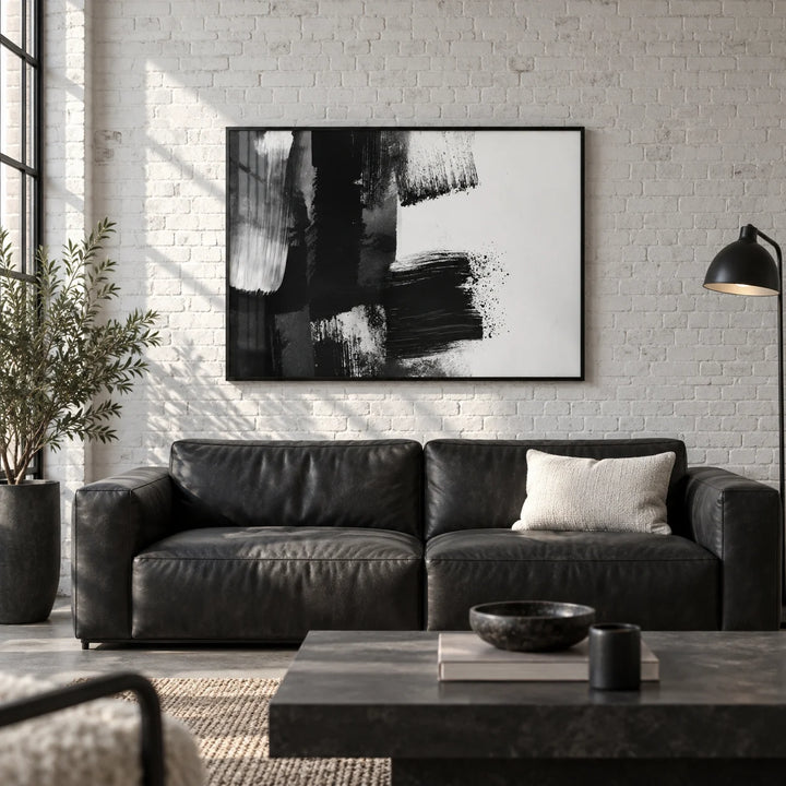 Black and White Art Print, framed on the wall of a industrial loft living room with a white painted brick wall and a concrete floor