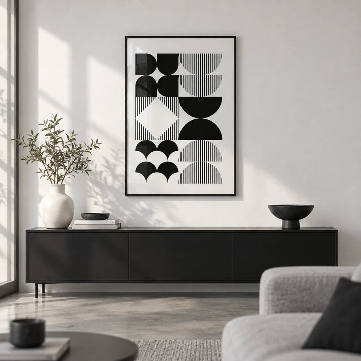 Black and White Geometric Wall Art, framed on the wall of a monochrome living room with a white wall and a polished concrete floor