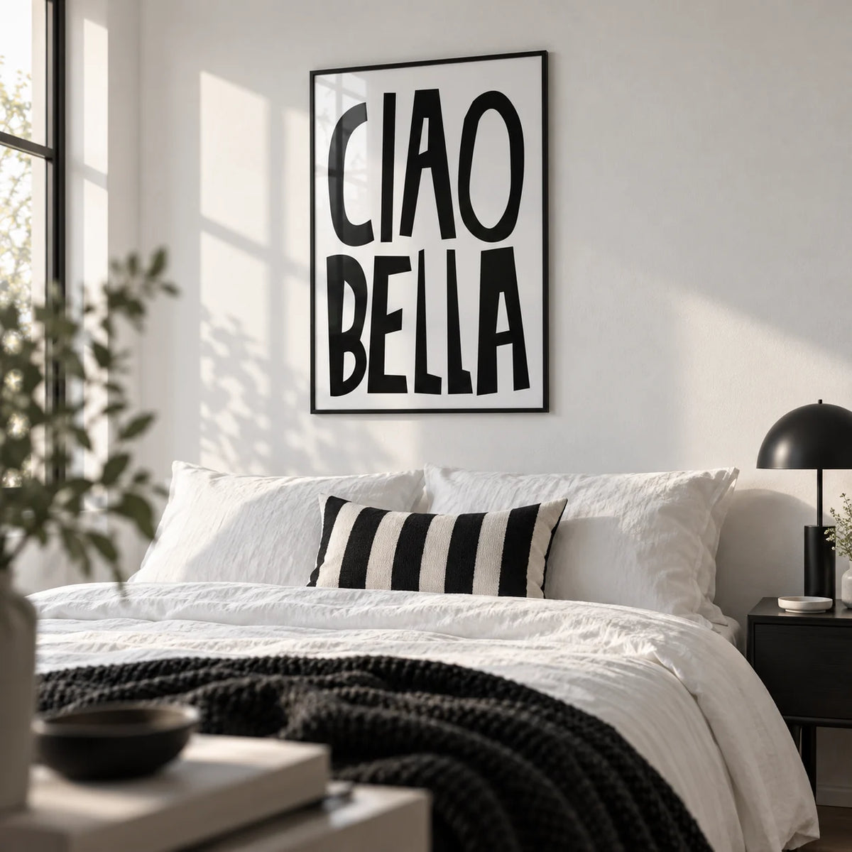 Black and White Typography Poster, framed on the wall of a crisp monochrome bedroom in a first flat
