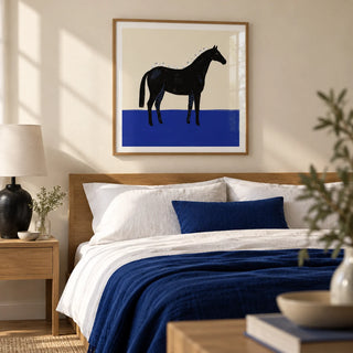 Black Horse Wall Art, framed on the wall of a calm adult bedroom with a cream wall and simple oak furniture