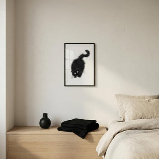 Arched Back Cat Print in black and white line-art above a wooden bedside table with textiles