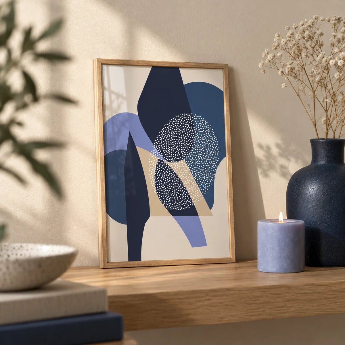 Blue Abstract Print, a small A4 framed print leaning on an oak shelf in a living room
