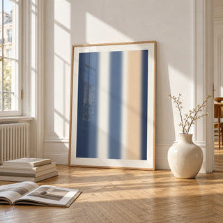 Blue and Cream Wall Art, framed and leaning on the parquet floor of a bright living room