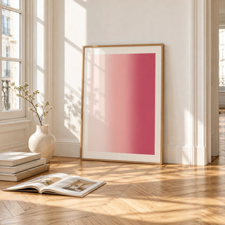 Blush Pink Wall Art, framed and leaning on the parquet floor of a bright living room