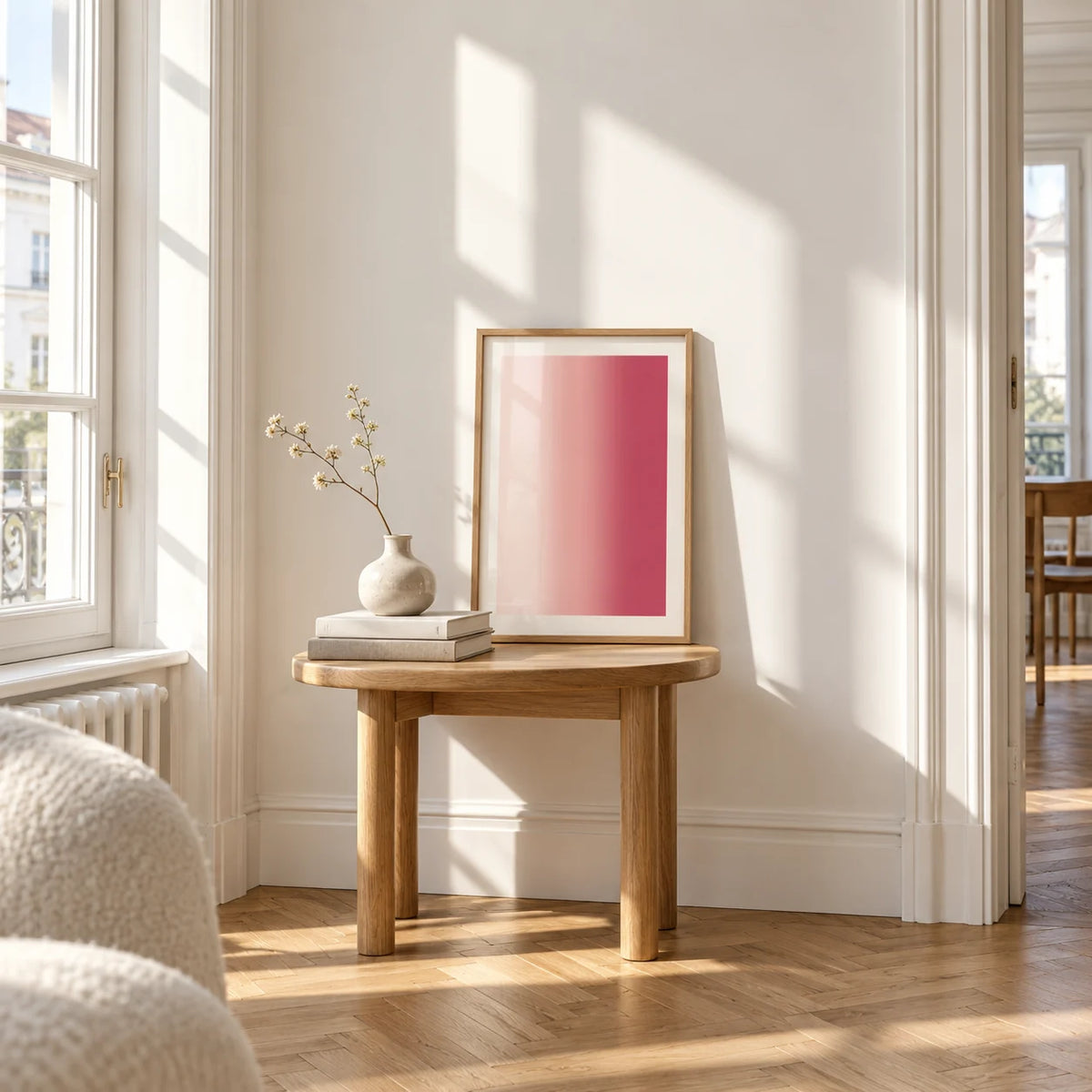 Blush Pink Wall Art, a small A4 framed print leaning on a small solid oak side table