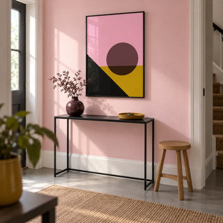 Bright Colored Artwork, framed on the wall of a crisp hallway in a renovated UK terrace with a pale pink wall and plain grey floor