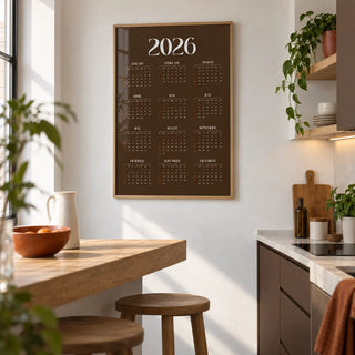 Brown Calendar Print, framed on the wall of a compact modern kitchen in a first flat (22-28) with plain white walls and chocolate brown lower cabinets