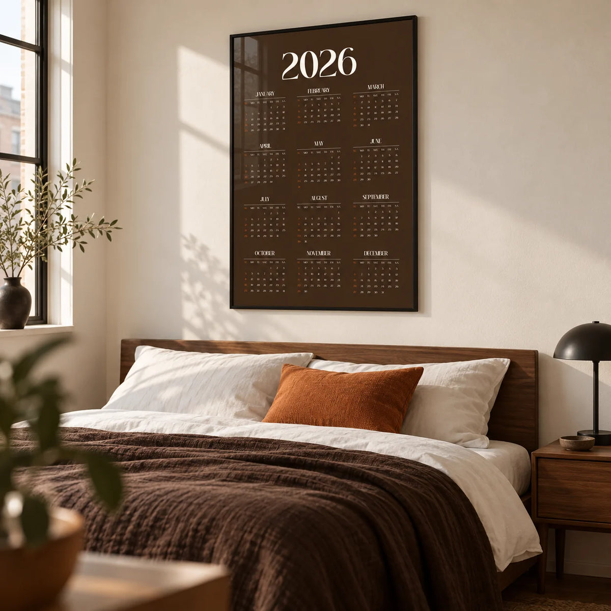 Brown Calendar Print, framed on the wall of a modern bedroom in a design-conscious city flat with a warm white wall