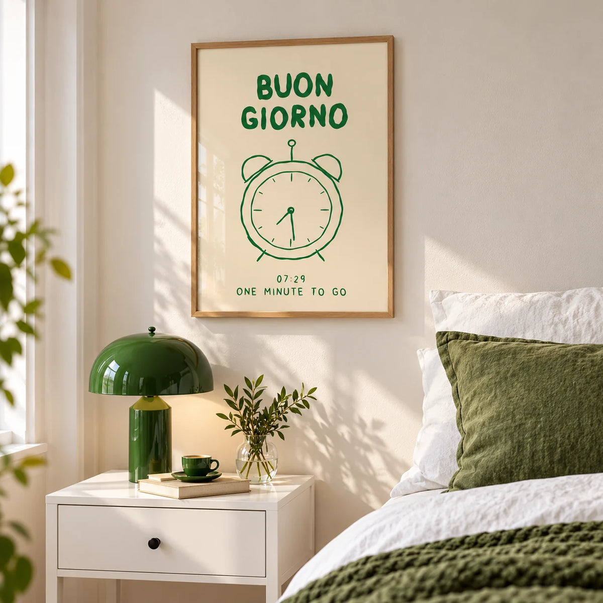 Buongiorno Print, framed on the wall of a bedroom above a bedside table with a green lamp