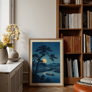 Moonlight Print leaning on the floor with a flower pot and bookshelf nearby in a softly lit room
