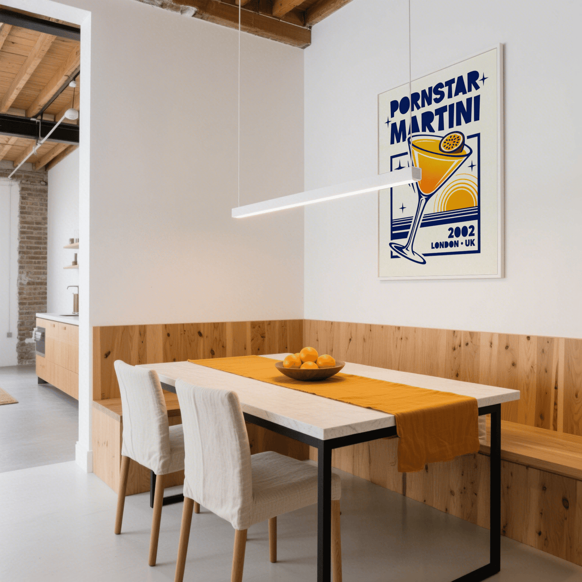 Retro Passion Fruit Martini Poster print on a dining room wall with wooden panelling and a bowl of oranges on the table