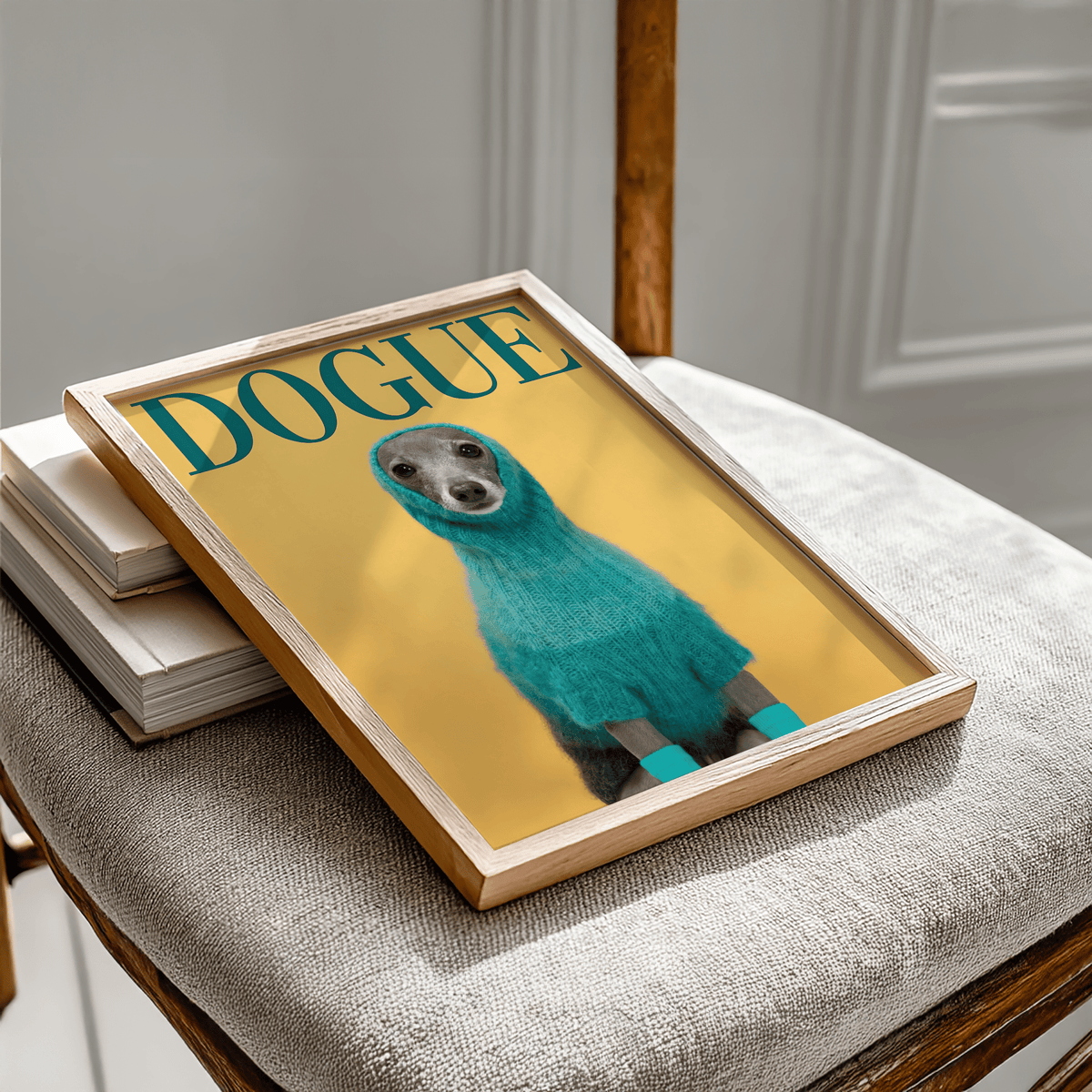 Framed cute pet wall art of a dog in a bright blue sweater on a yellow background leaning on a chair with books
