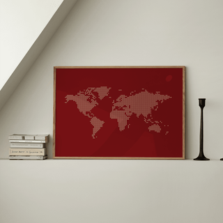 World Map Wall Poster leaning on a white shelf with stacks of books and a black candle holder