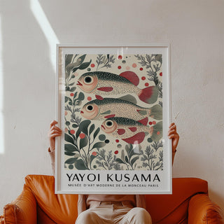 Wall Art of Fish framed print held by person showing redfin fish trio with botanical illustration style