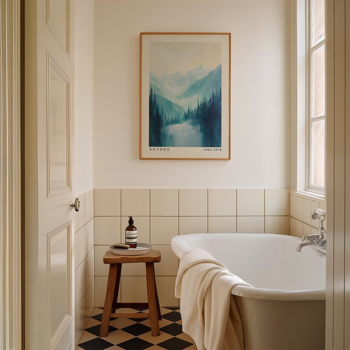 Nature print of pine trees and mountains in soft blue hues above a wooden stool in a bathroom