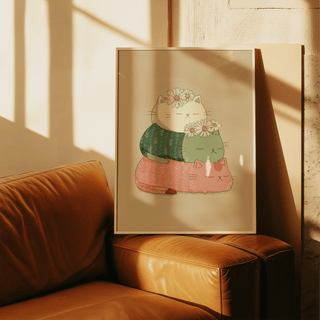Cute Cat Art Print leaning on a leather sofa with stacked cats and daisies in soft colours