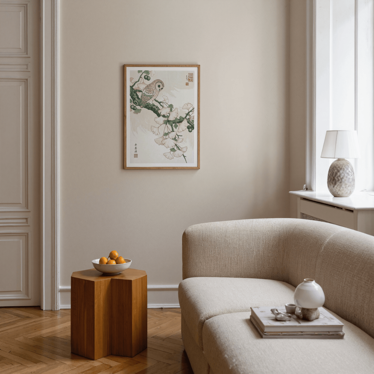 Owl art print Japanese woodblock style wall art with soft green and pink colours above a beige sofa