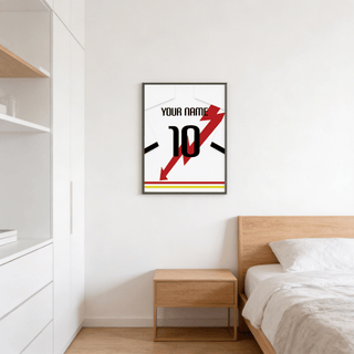 Football shirt poster in white with red lightning bolt on a bedroom wall above a wooden bedside table