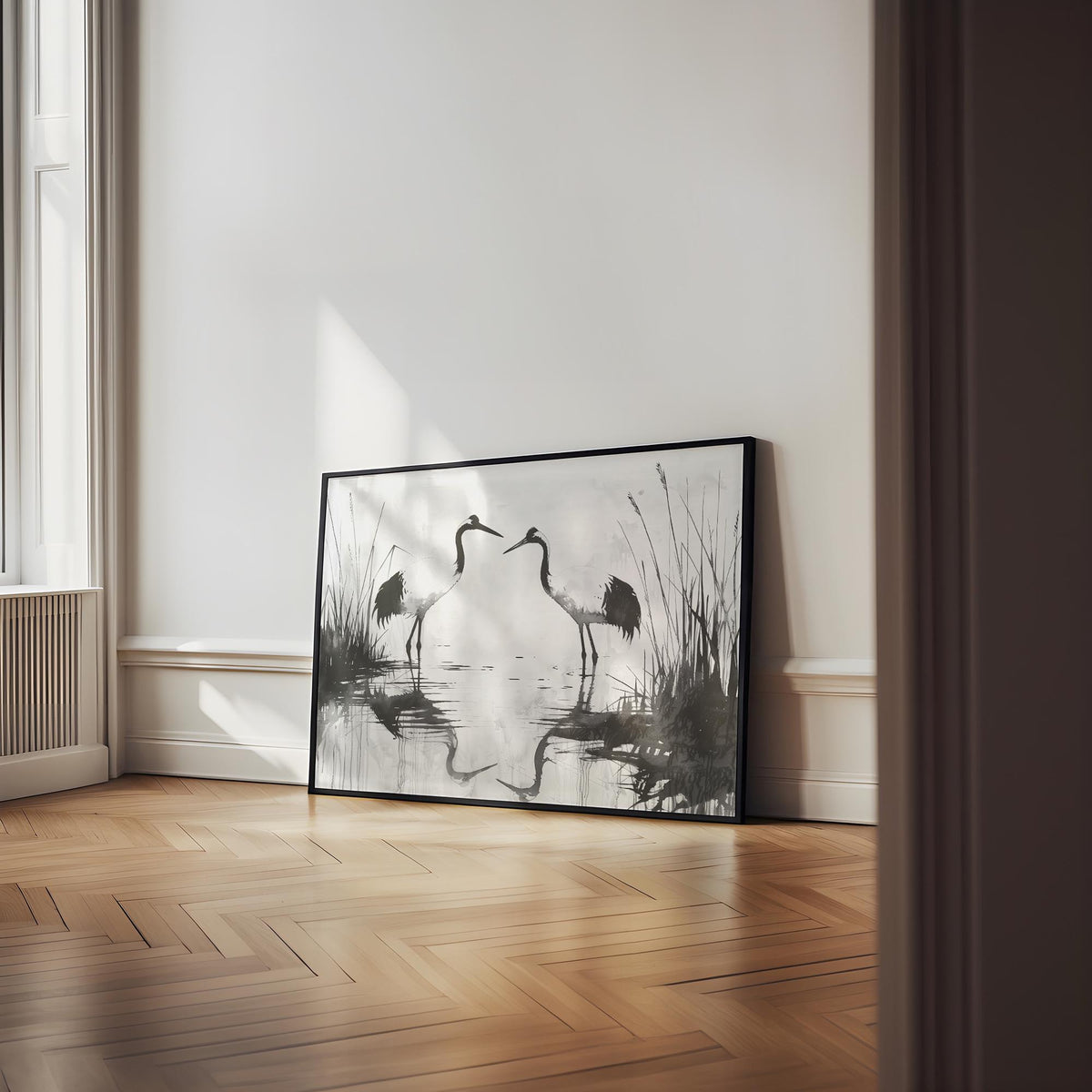 Minimalist Bird Art print of two cranes in black and grey tones leaning on a wooden floor in a bright room