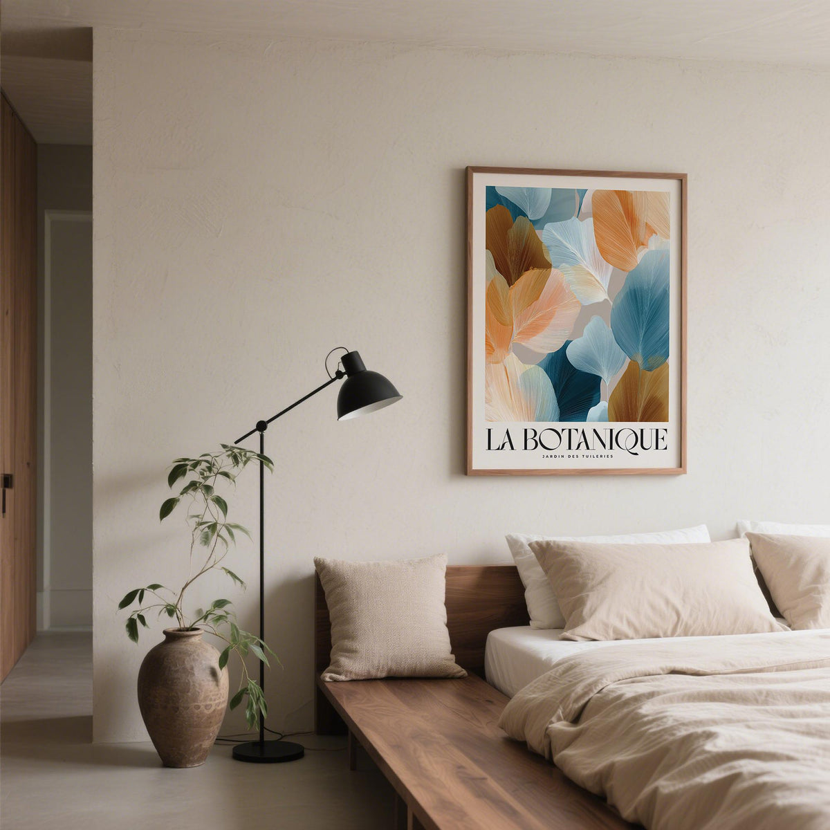 Flower art for walls featuring abstract botanical leaves in blue and orange above a bed