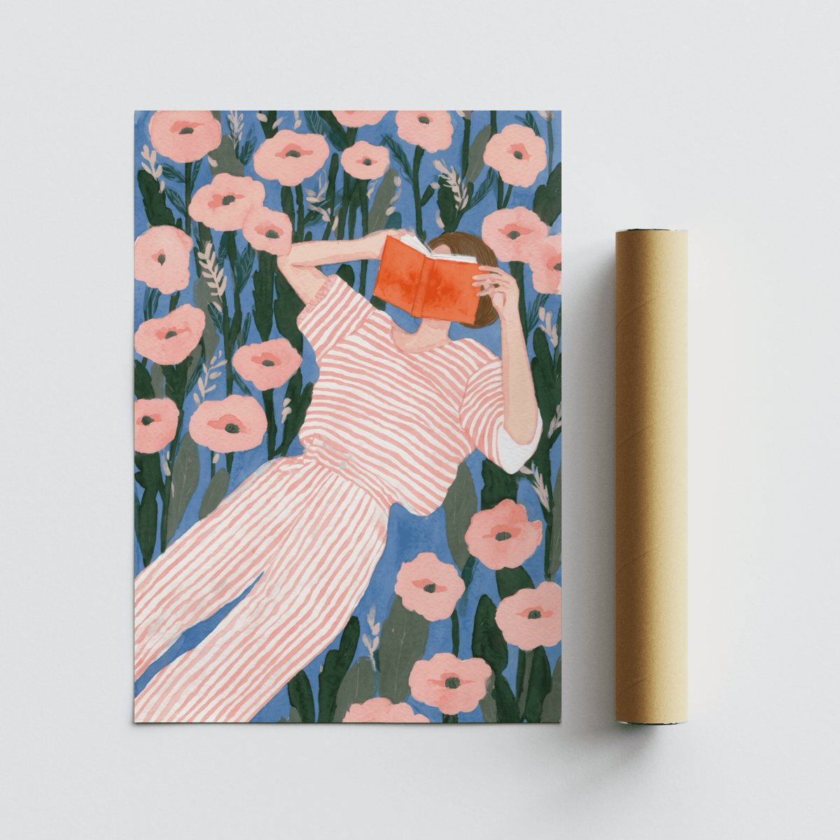 Woman Reading art print of a person with a striped outfit holding an orange book with floral background shown alongside a packaging tube