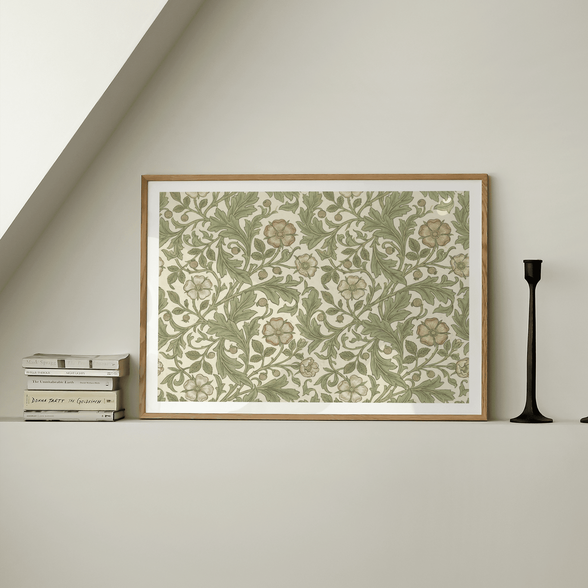 Framed Botanical Wall Decor with green and beige vintage floral pattern on a shelf with stacked books