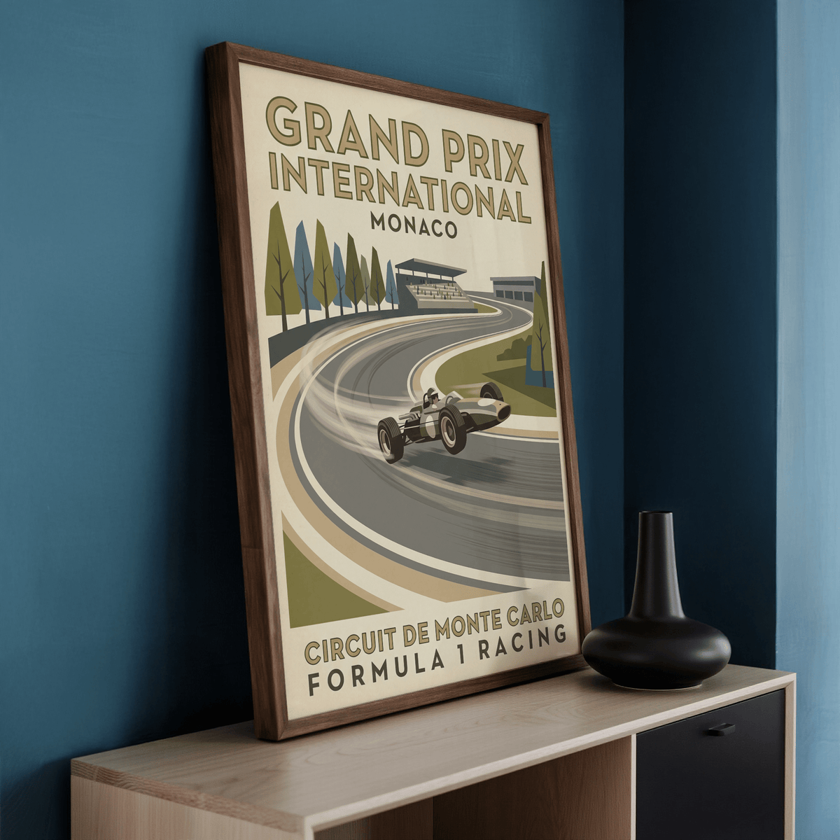 Print leaning on a shelf of Vintage Open Wheel Racing Print with retro track scene and muted colours near a black vase