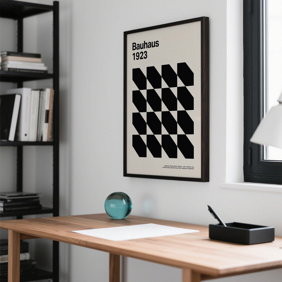 Corporate office artwork of a black geometric shapes grid in a minimalist style above a wooden desk