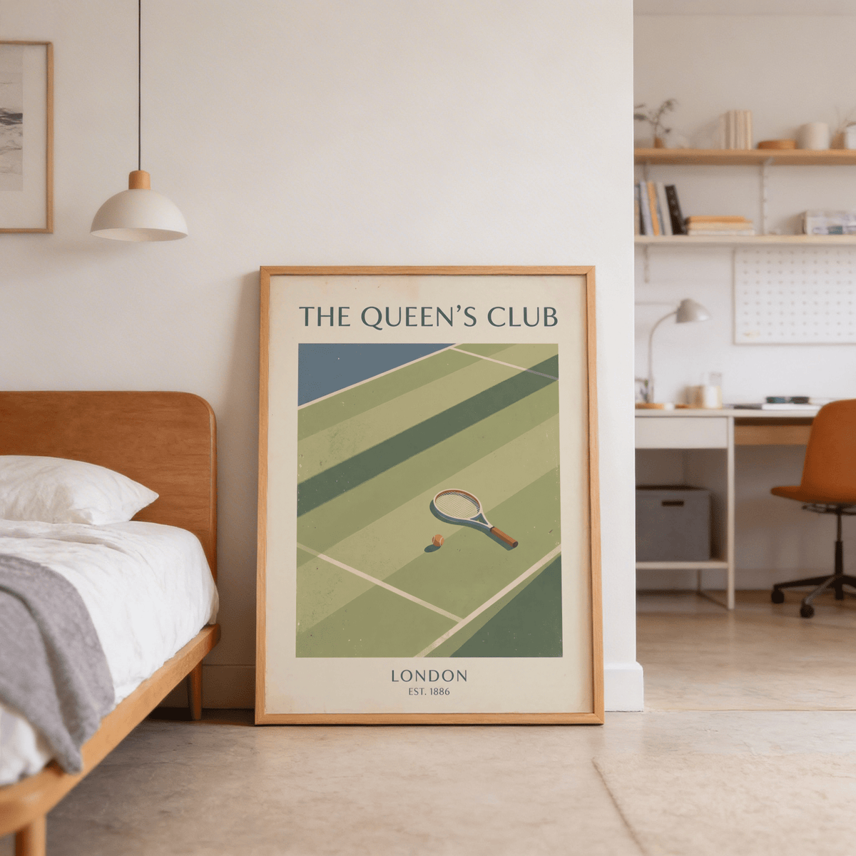 Tennis wall art leaning on floor in a bedroom with wooden bed and hanging lamp