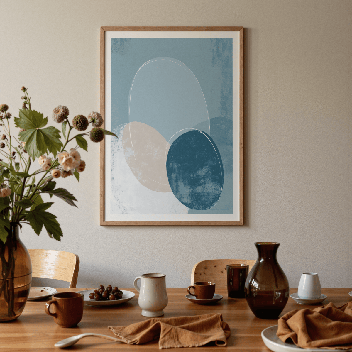 Geometric Circle Poster on a beige wall above a wooden dining table with a vase and cups