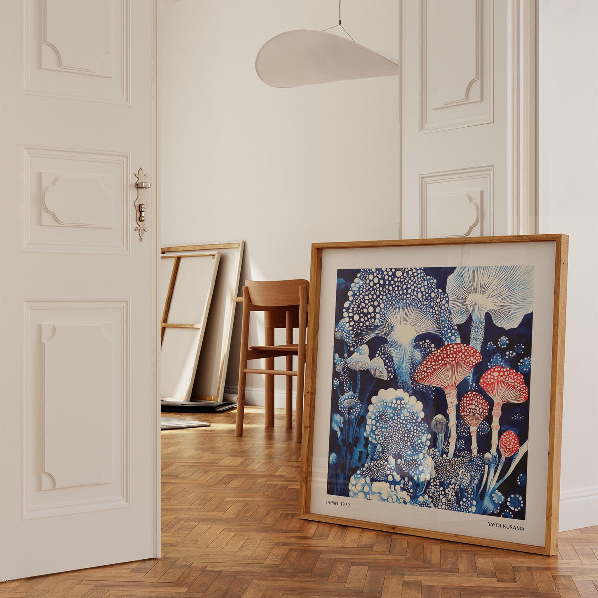 Japanese Poster print leaning on a wooden floor with red and blue toadstools mushrooms in a minimalist room