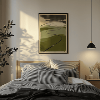 Golf Course Art Print above a bed with striped pillows in a softly lit bedroom