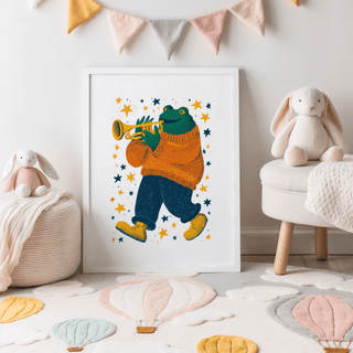 Frog Playing Trumpet Art print leaning on a children's room floor with plush toys and a bunting