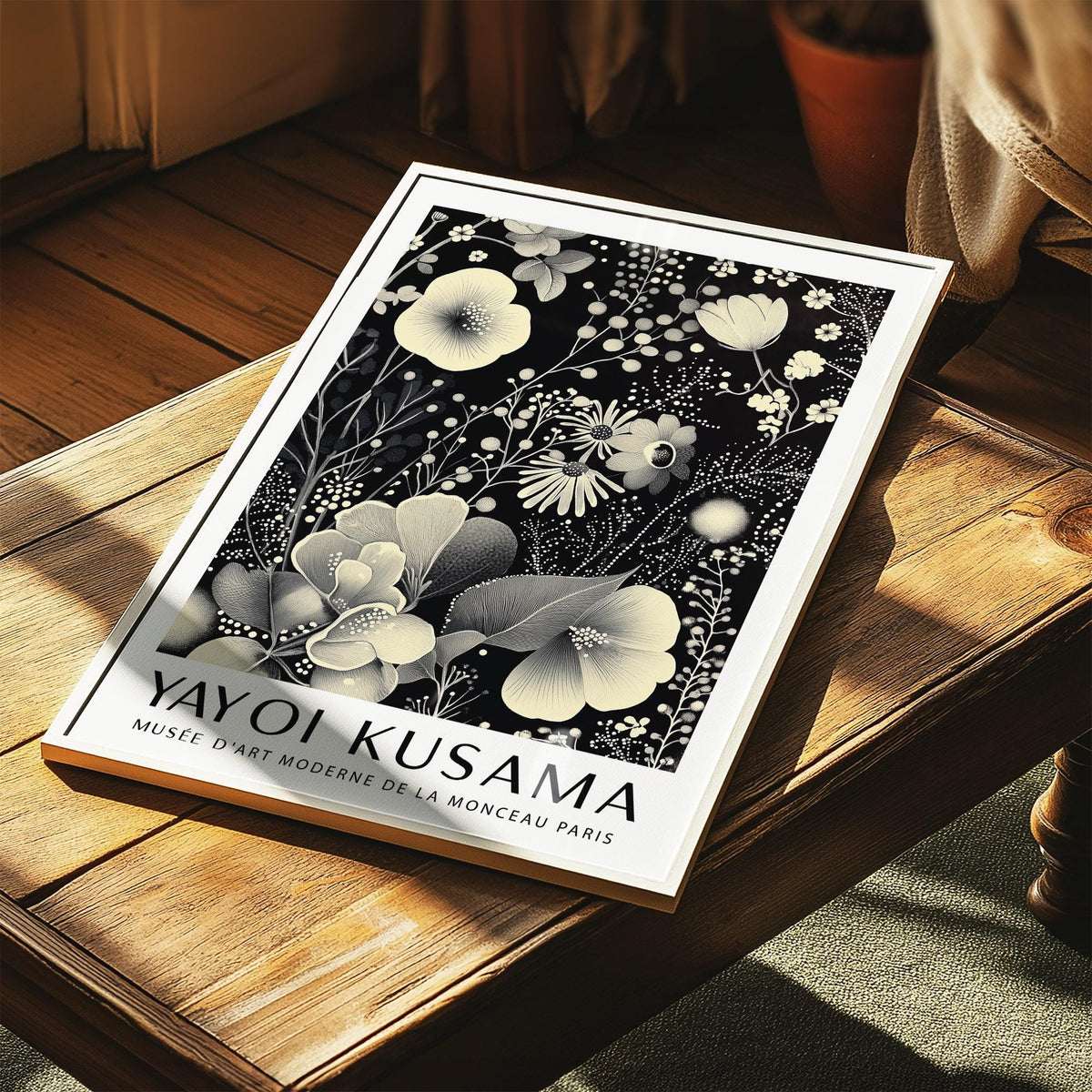 Large Floral Wall Art illustration with ivory florals on black placed on wooden table in sunlight