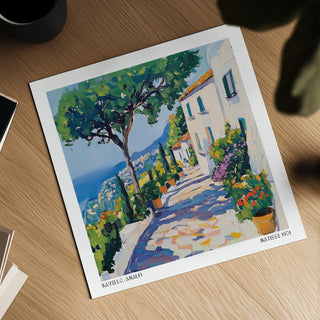 Print of Amalfi Coast with a Mediterranean path and trees on a wooden surface next to a cup